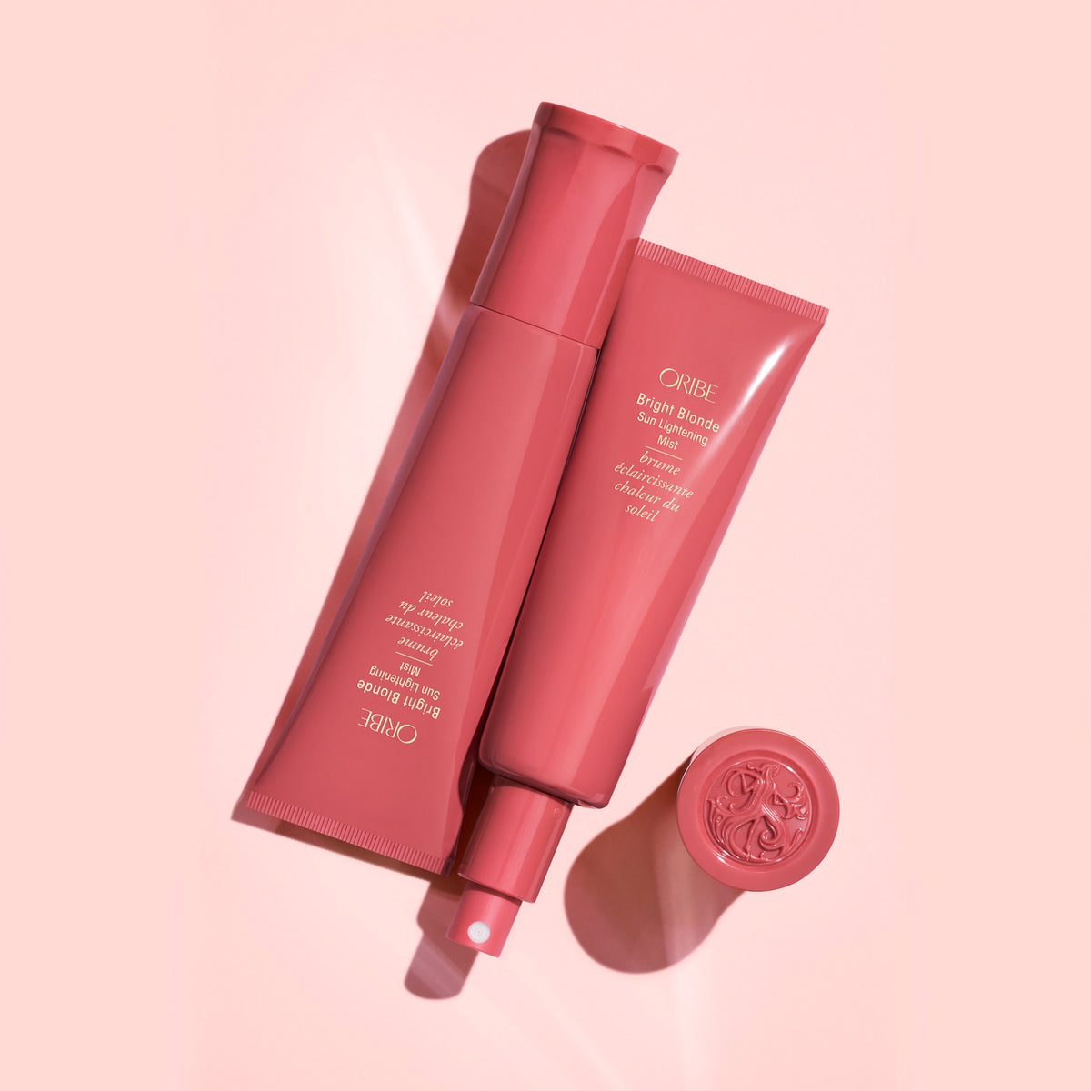 Oribe Bright Blonde Sun Lightening Mist in an editorial flat lay showcasing the luxury brightening mist designed for blonde and highlighted hair.