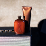 Oribe Shampoo and Conditioner for Magnificent Volume displayed on a vintage amplifier