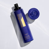 Oribe Run-Through Detangling Primer open spray bottle and product detail.