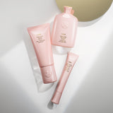 Oribe Serene Scalp Soothing Leave-On Treatment shown with Serene Scalp Anti-Dandruff Shampoo and Balancing Conditioner on a white background