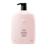 Oribe - Serene Scalp shampoo liter sized bottle. Baby pink color bottle with gold letting and black pump top.