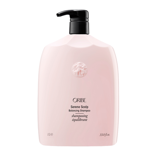 Oribe - Serene Scalp shampoo liter sized bottle. Baby pink color bottle with gold letting and black pump top.