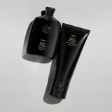 Oribe Signature Shampoo and Conditioner arranged with sculptural shadows