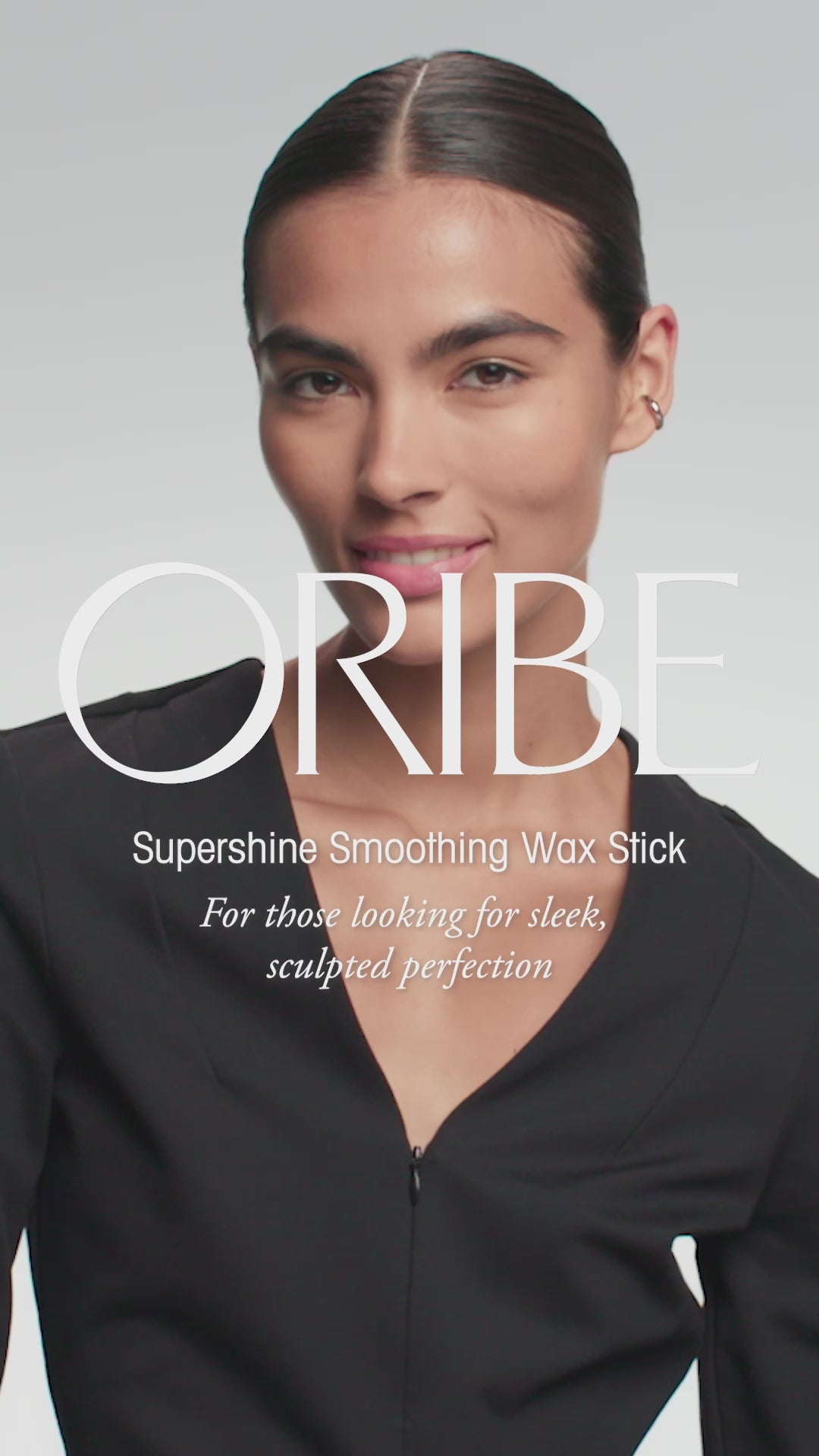 Oribe Supershine Smoothing Wax Stick product video showing smooth flyaway control, polished shine, and a sleek finished style.