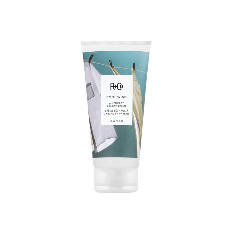 R+Co - COOL WIND creme bottle with flip top cap on bottom and air drying laundry graphics