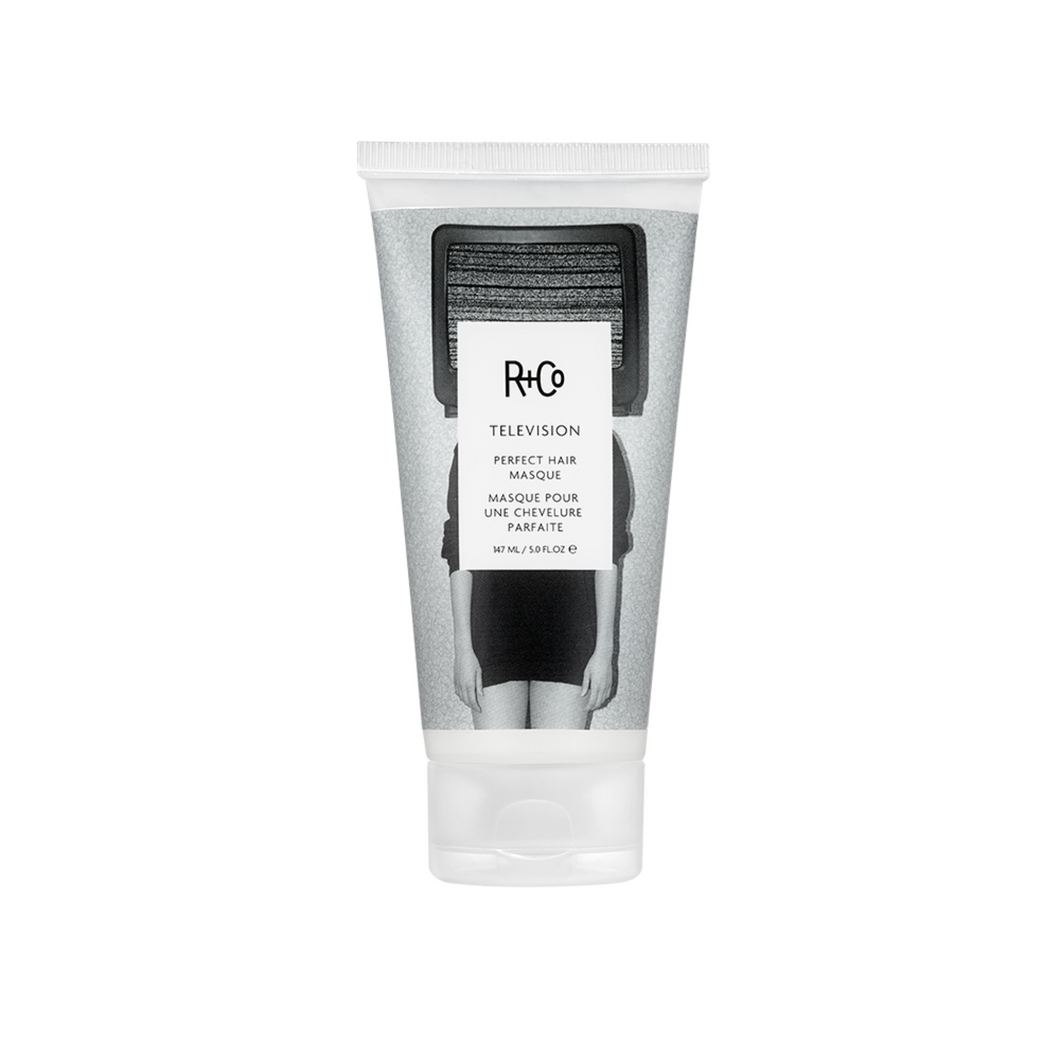 R+Co - TELEVISION Masque bottle with flip cap on bottom and black and white photo background