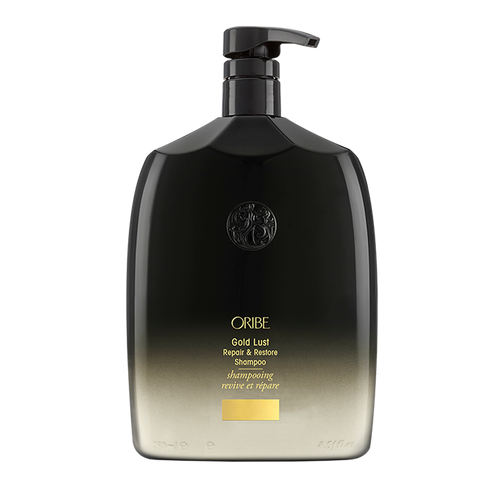 Oribe - GOLD LUST Shampoo liter sized rounded bottle with black to cream ombre and gold lettering. Black top with pump