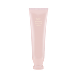Oribe Serene Scalp Exfoliating Scrub 125 ml in a pale pink tube, shown upright from the front