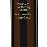 Oribe Grandiose Hair Plumping Mousse for volume and body — 2.5 oz travel size.