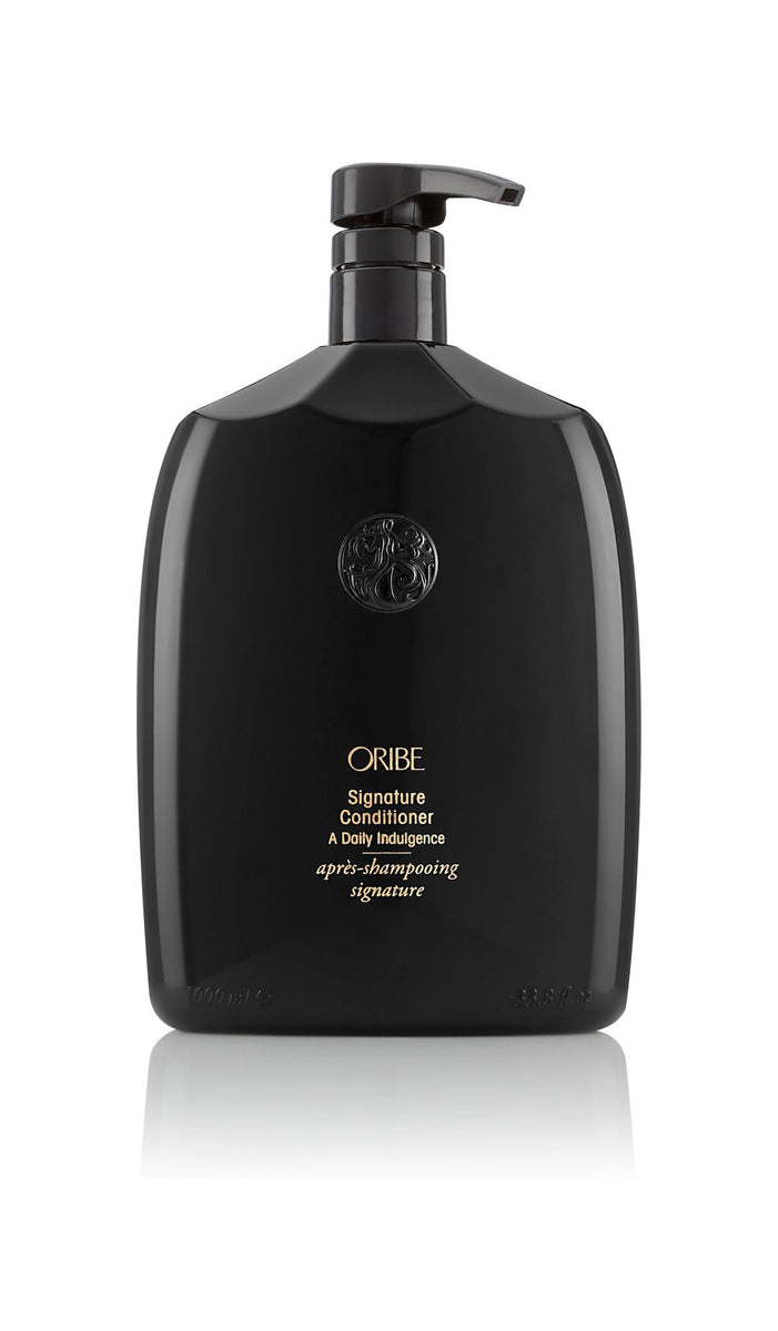 Oribe Signature Conditioner for all hair types — 1.7 oz travel size.