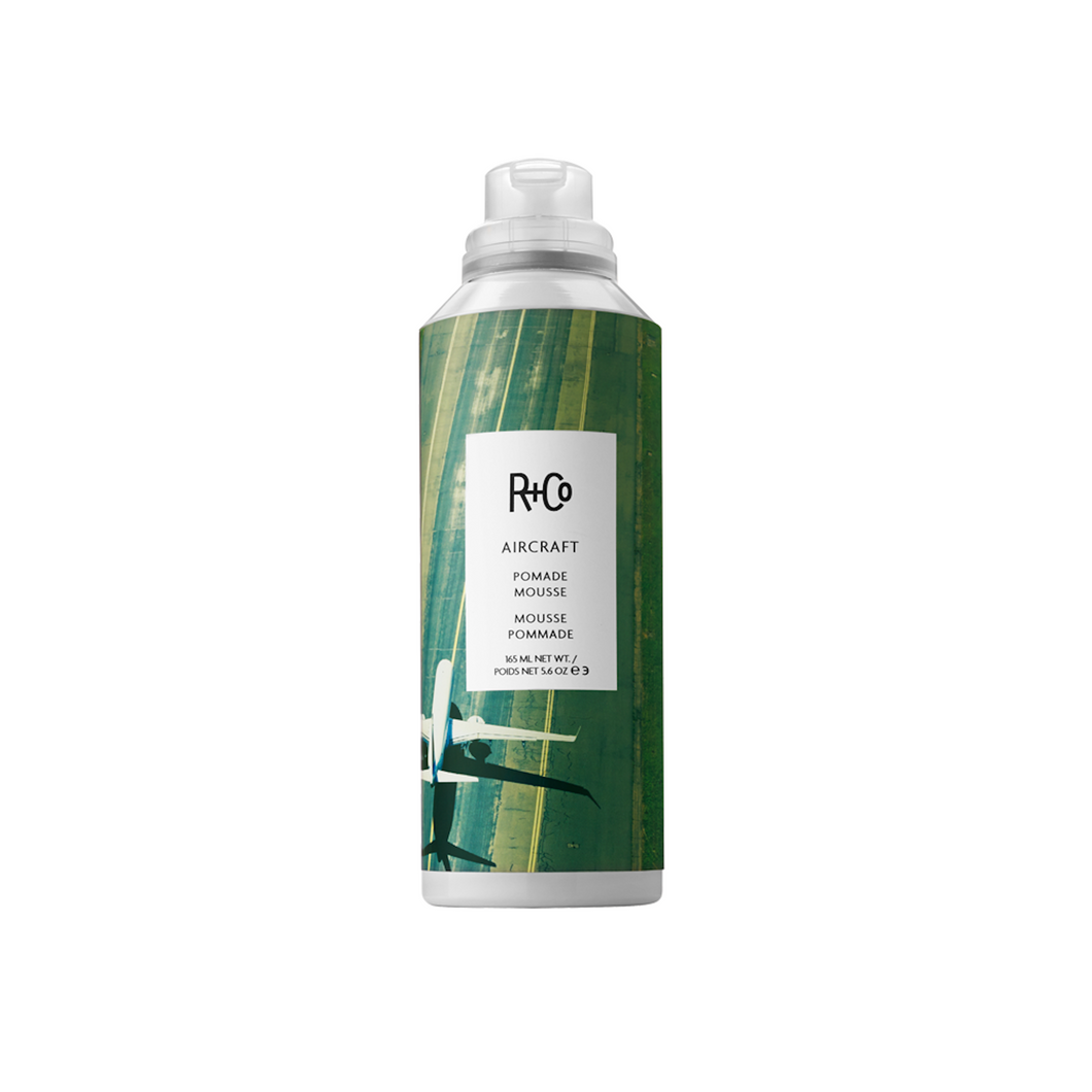 R+Co - AIRCRAFT Mousse bottle with green background 