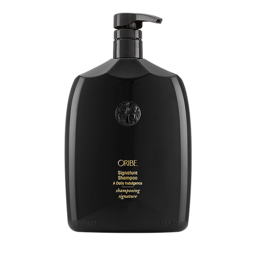 Oribe - SIGNATURE Shampoo liter sized rounded bottle. All black with gold lettering and pump top